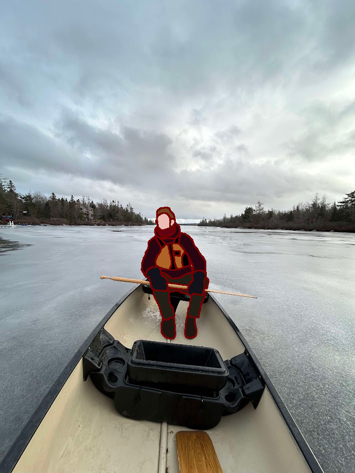 Mark in the canoe on the frozen lake.