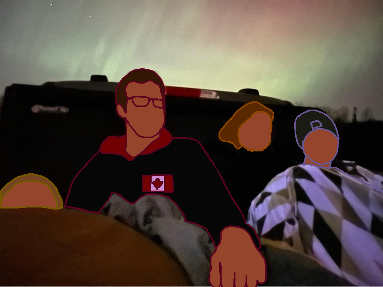 Some of our group sitting in the back of the truck watching the aurora.