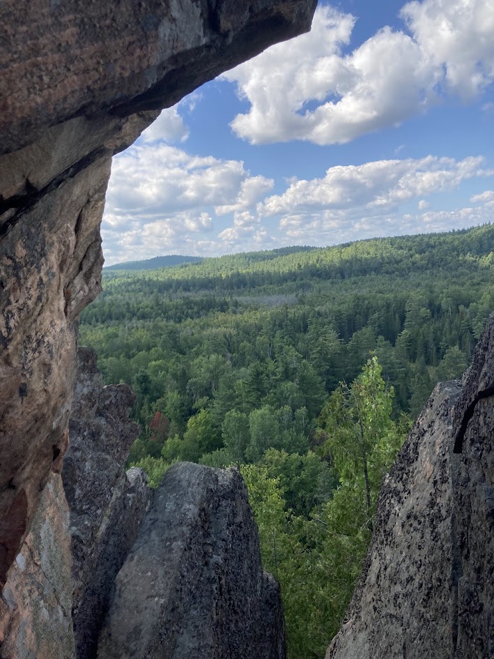 A lookout off a cliff with the rock framing the landscape.